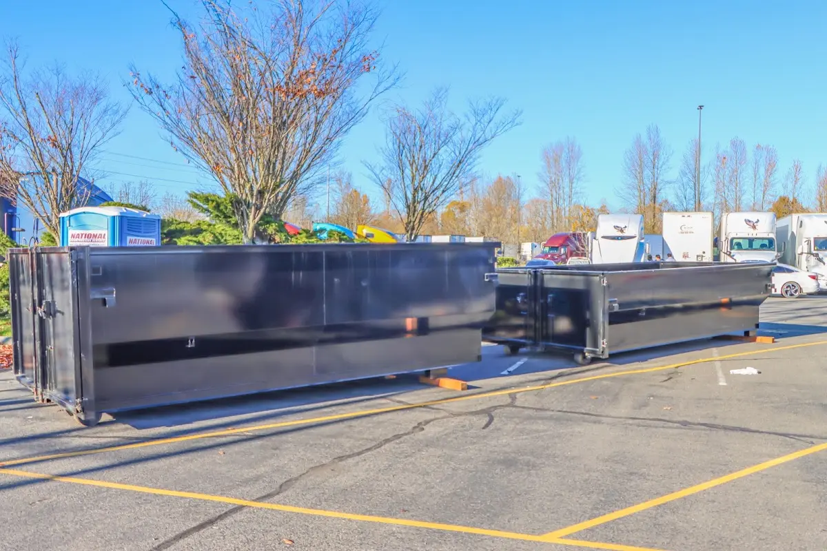 Professional dumpster rental service with roll-off container on residential driveway in Port Hueneme